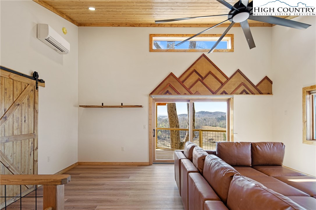 330 Maplewood Circle Boone, NC 28607 - Photo 18 of 44 a living room with furniture and a floor to ceiling window