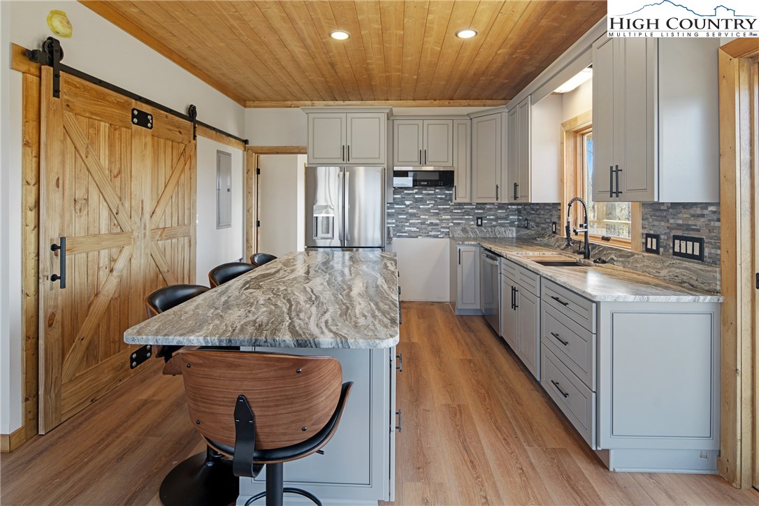 330 Maplewood Circle Boone, NC 28607 - Photo 5 of 44 a kitchen with stainless steel appliances granite countertop a sink refrigerator and cabinets