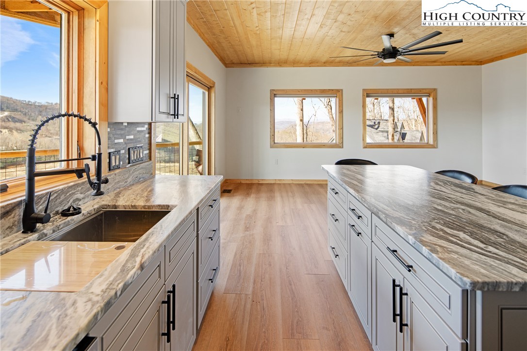 330 Maplewood Circle Boone, NC 28607 - Photo 6 of 44 a kitchen with granite countertop a stove and a sink