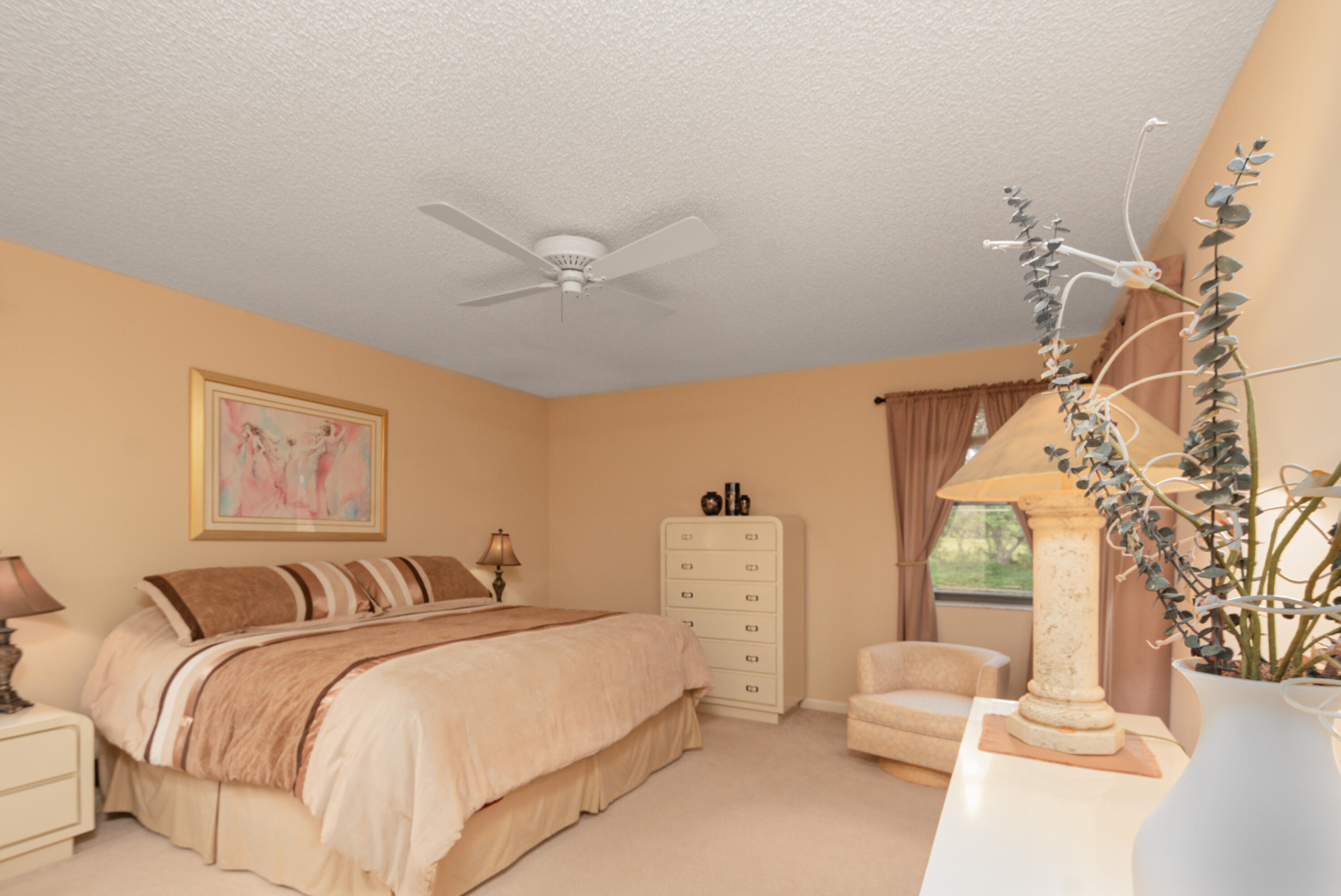 10867 Waterberry Court Boca Raton, FL 33498 - Photo 14 of 30 a bedroom with a bed and a chandelier