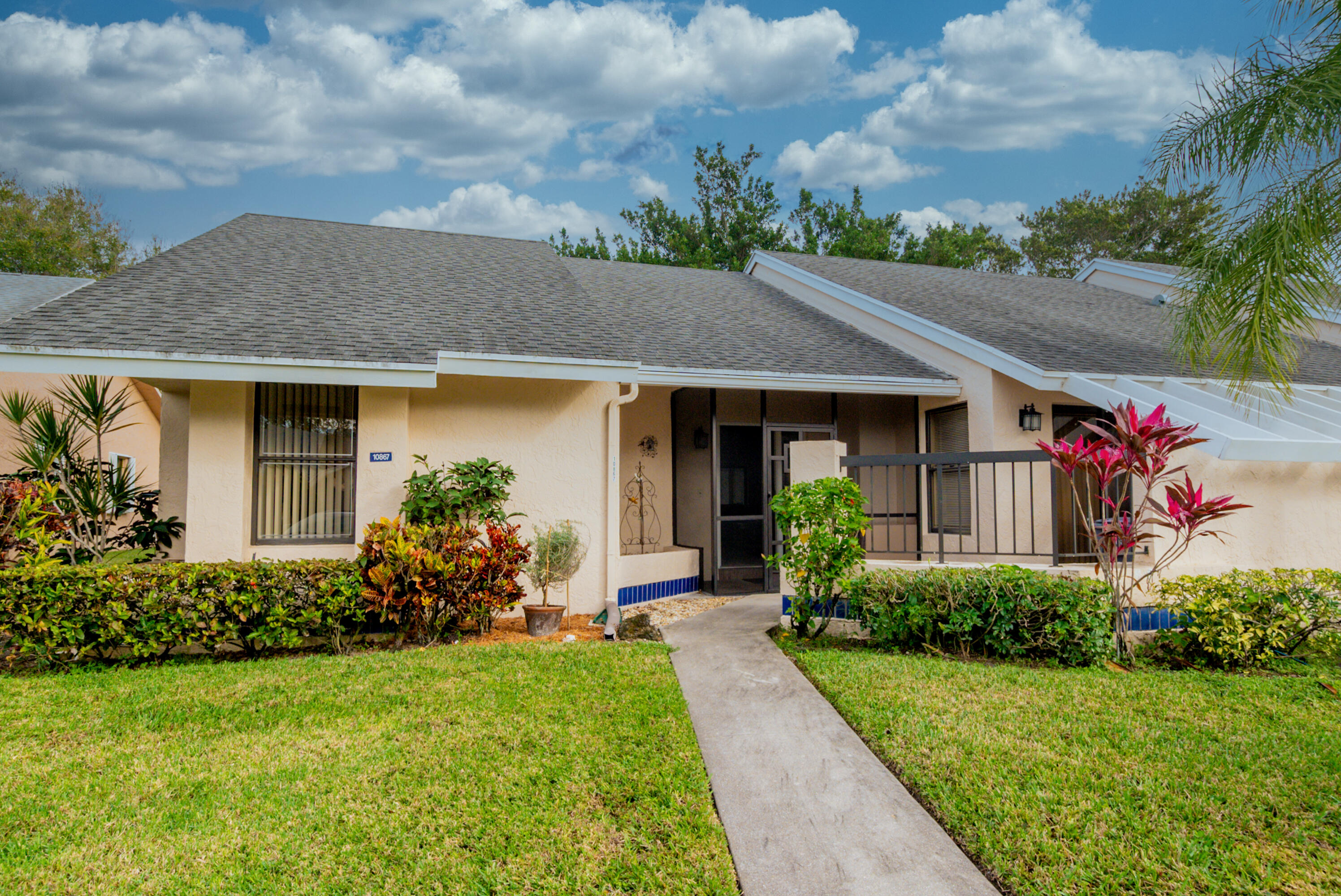 10867 Waterberry Court Boca Raton, FL 33498 - Photo 18 of 30 a front view of a house with garden