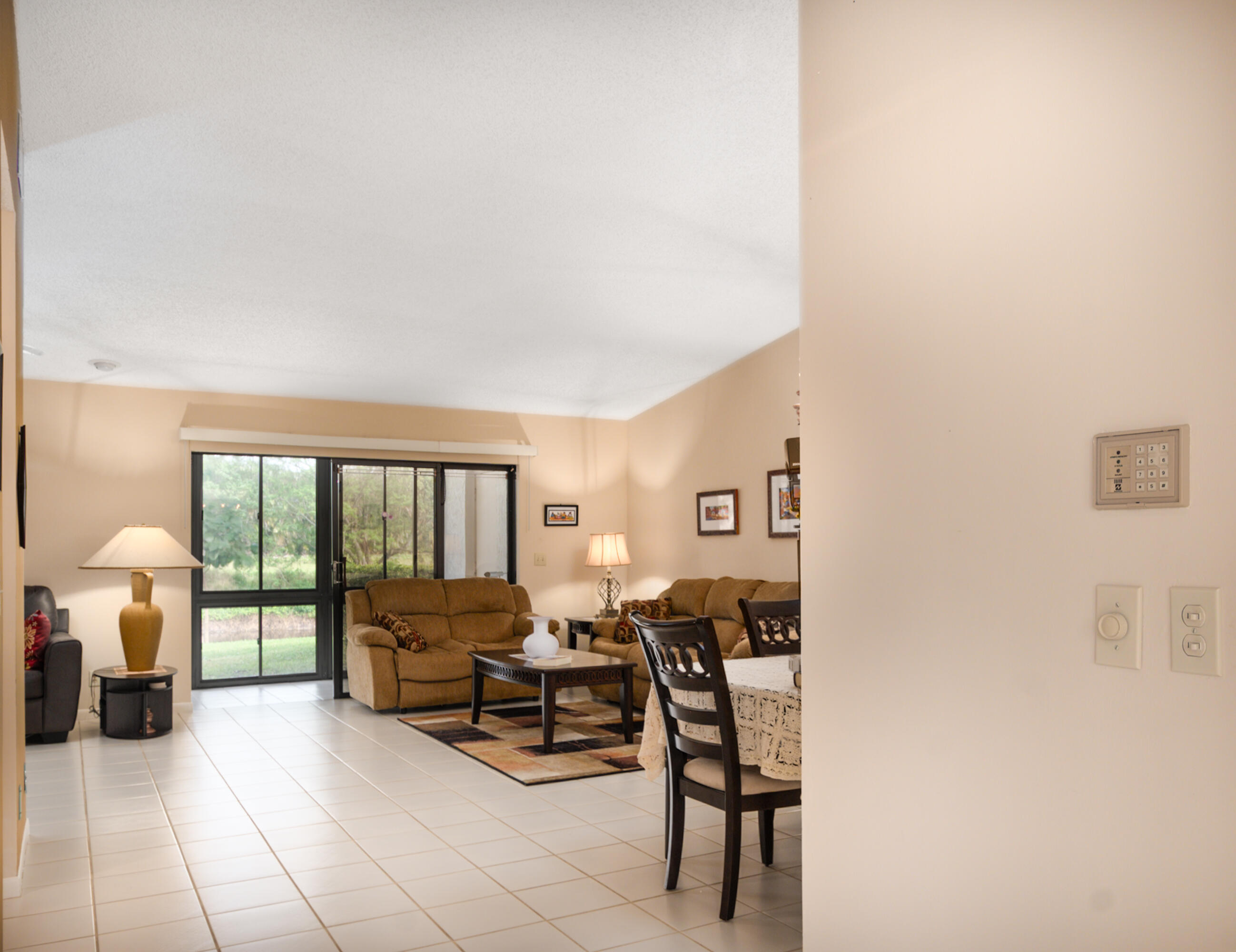 10867 Waterberry Court Boca Raton, FL 33498 - Photo 22 of 30 a living room with furniture and a lamp