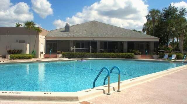 10867 Waterberry Court Boca Raton, FL 33498 - Photo 30 of 30 a view of a patio with couches table and chairs with potted plants and palm trees