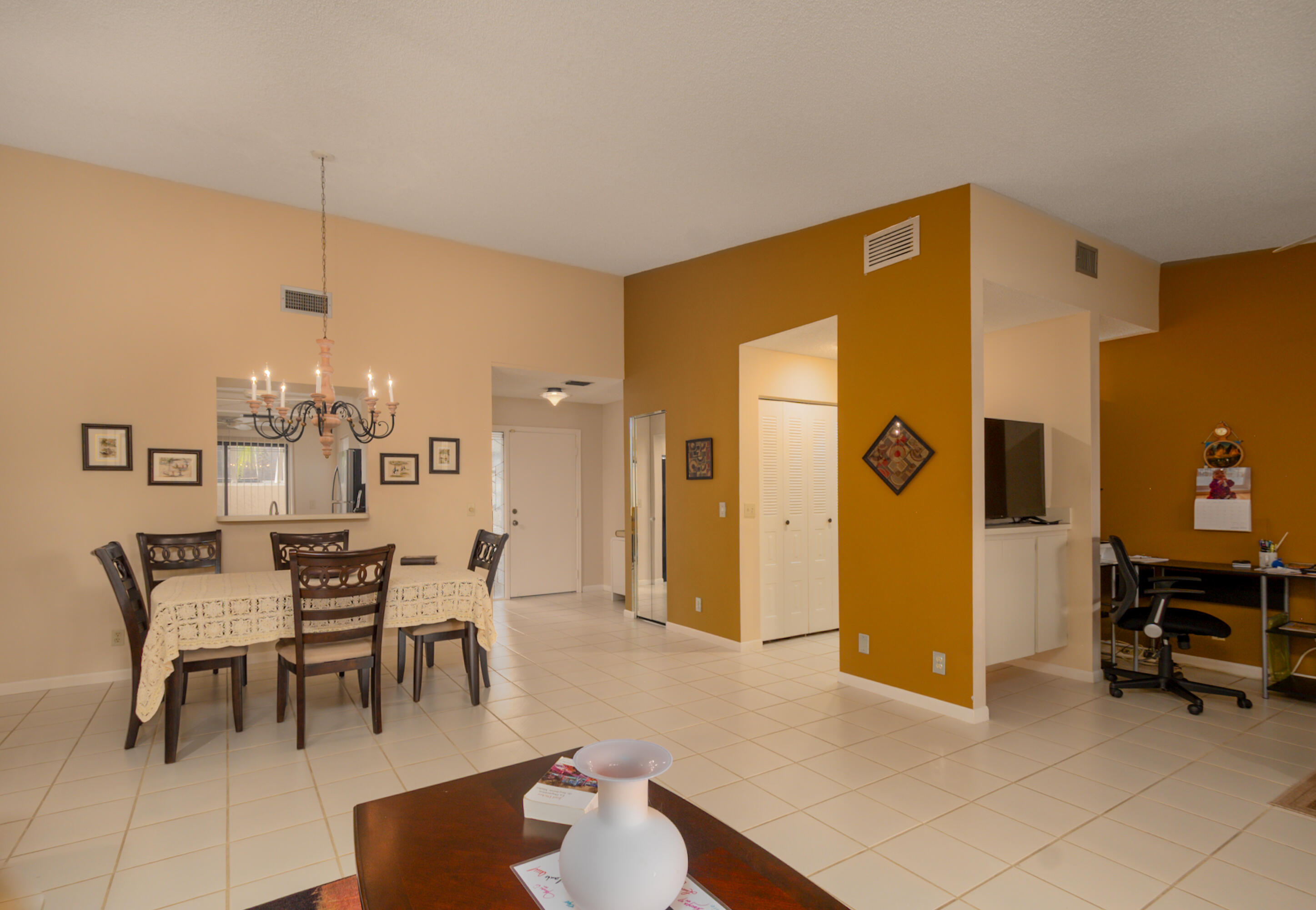 10867 Waterberry Court Boca Raton, FL 33498 - Photo 4 of 30 a view of a dining room with furniture and chandelier