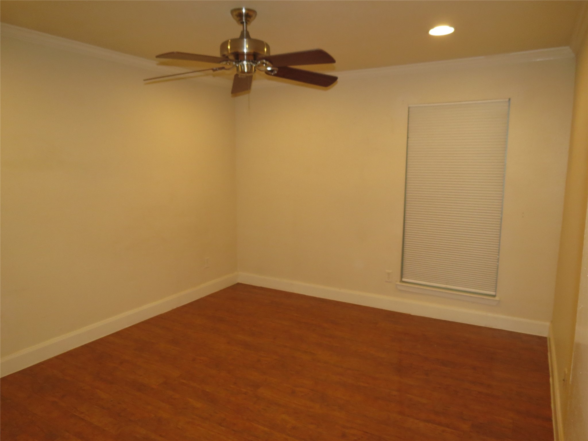4159 Steck Avenue, Unit 269 Austin, TX 78759 - Photo 11 of 21 Rich hardwood flooring complements a spacious room, illuminated by a ceiling fan and natural light.
