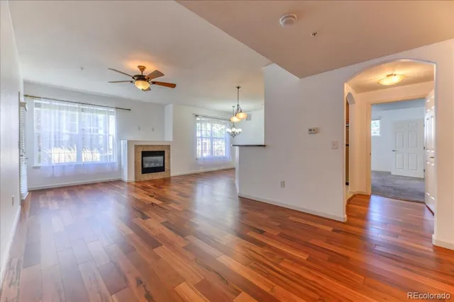 a view of an empty room with a fireplace and a window