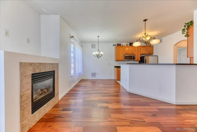 a view of a kitchen with cabinets and wooden floor