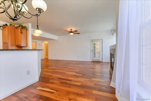 a view of a room with a window and wooden floor