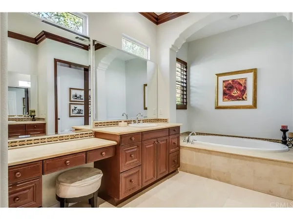 a spacious bathroom with a granite countertop sink and a mirror