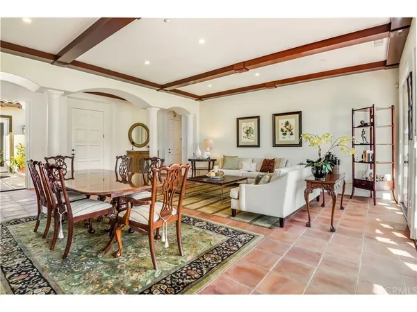 a living room with lots of furniture and view of kitchen