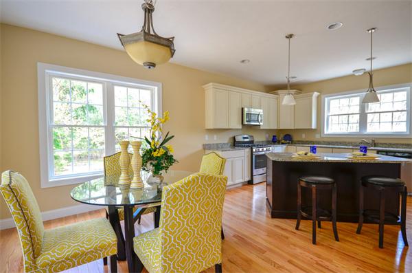 53 Great Road Stow, MA 01775 - Photo 3 of 23 a kitchen with stainless steel appliances granite countertop a stove a refrigerator a sink a dining table and chairs with wooden floor