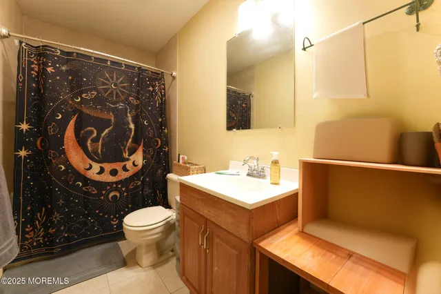 a bathroom with a sink a toilet and a mirror