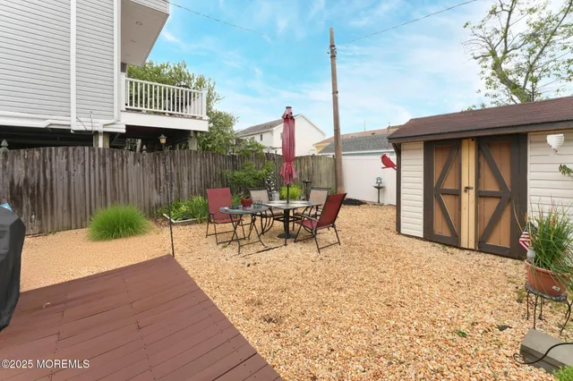 a view of a patio with a table chairs and potted plants