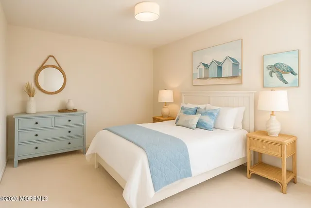 a bedroom with a bed and a lamp on dresser