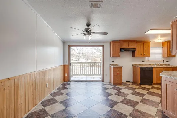 a view of a kitchen with a sink and a living room