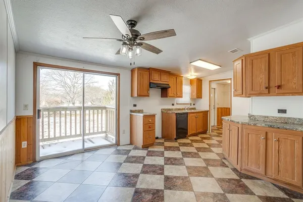 a open kitchen with stainless steel appliances granite countertop a sink and a cabinets