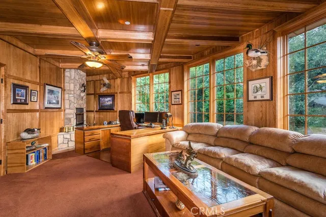 a living room with furniture a flat screen tv and a table