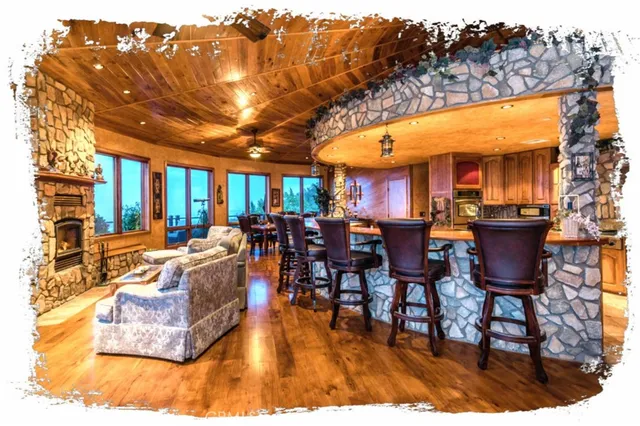 a view of a dining room with furniture a chandelier and mountain view