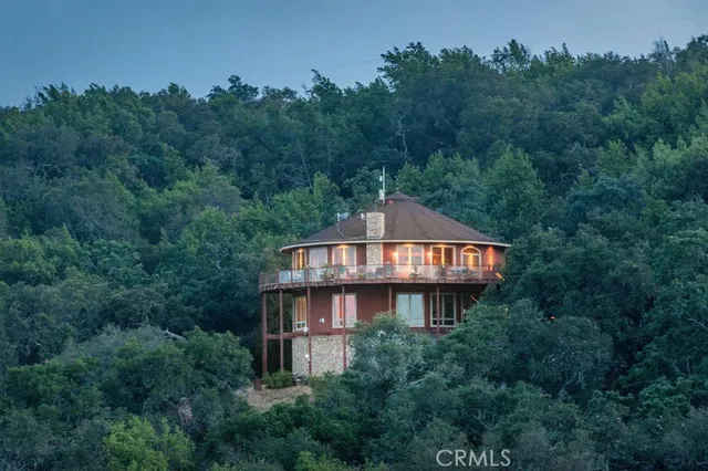 a balcony with wooden floor and outdoor seating