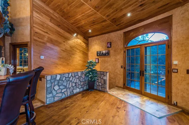 a dining room with furniture window and wooden floor
