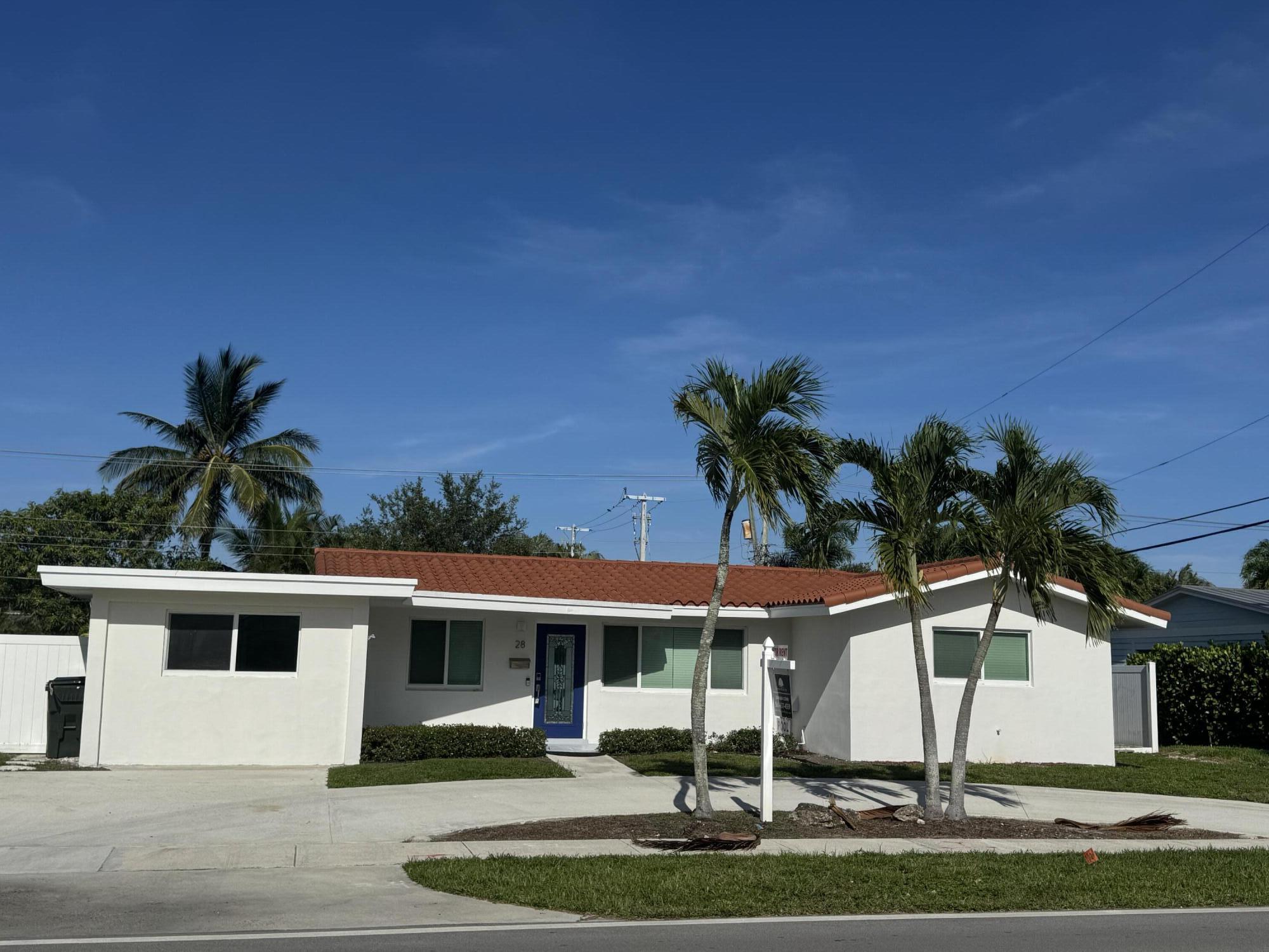 28 Southwest 9th Avenue Boca Raton, FL 33486 - Photo 1 of 16 a front view of a house with a yard