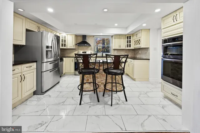 a kitchen with granite countertop a sink a stove and cabinets
