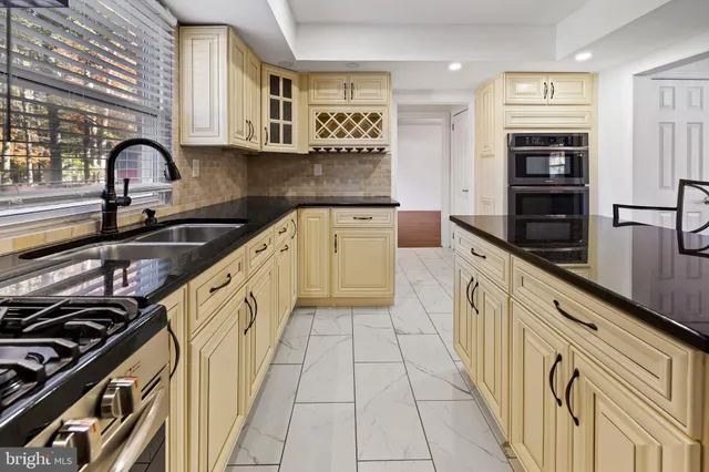 a kitchen with stainless steel appliances granite countertop a stove and a refrigerator