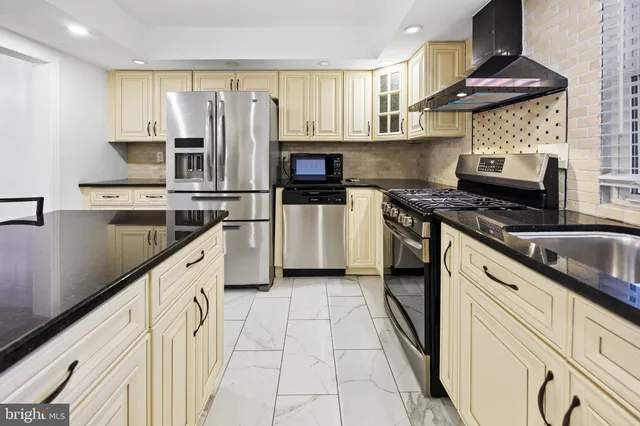 a kitchen with a stove and a refrigerator