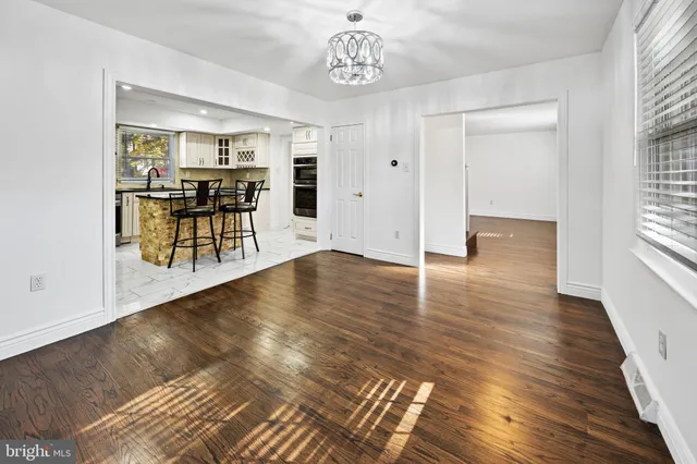 a view of a room with wooden floor