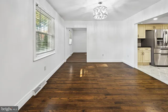 a view of an empty room and wooden floor