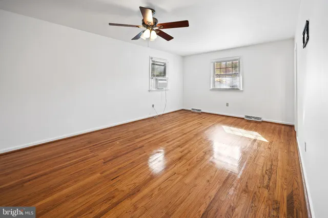 a view of an empty room and wooden floor