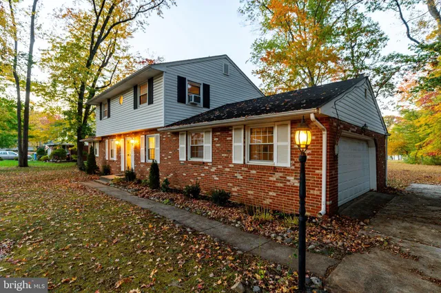 a living room with furniture chandelier and a flat screen tv