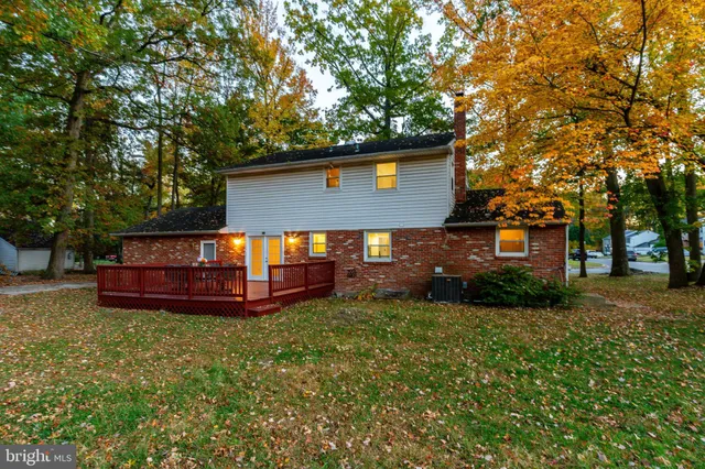 a view of a yard with wooden fence