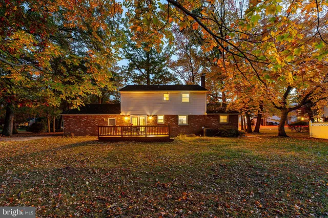 a view of a yard with wooden fence