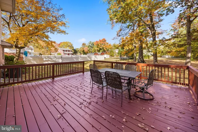 a view of a yard with wooden fence