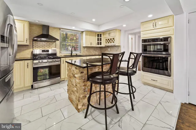a kitchen with stainless steel appliances granite countertop a stove and a cabinets