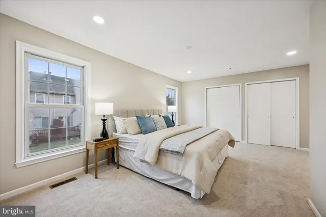 a spacious bedroom with a bed and a window