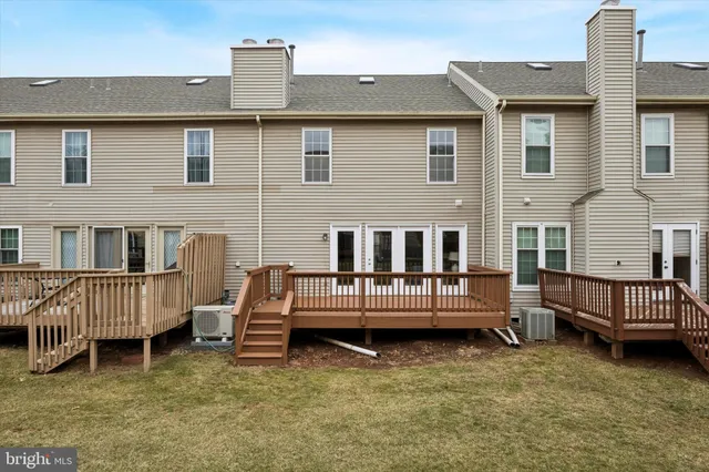a view of a house with a fence in a backyard