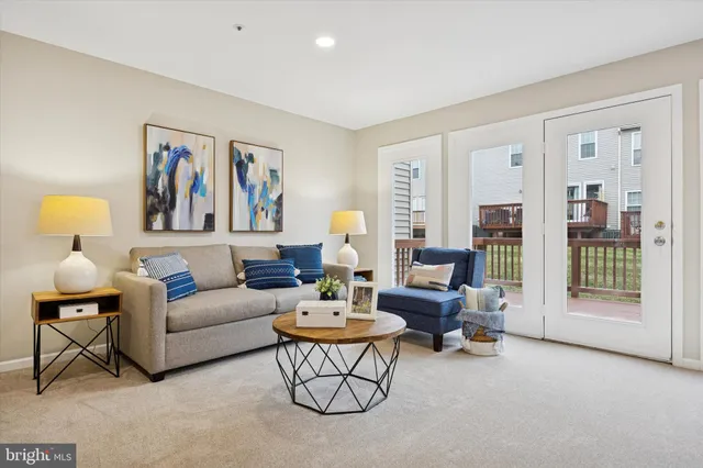 a living room with furniture a lamp and a chandelier