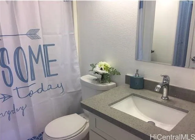 a bathroom with a sink a toilet and mirror