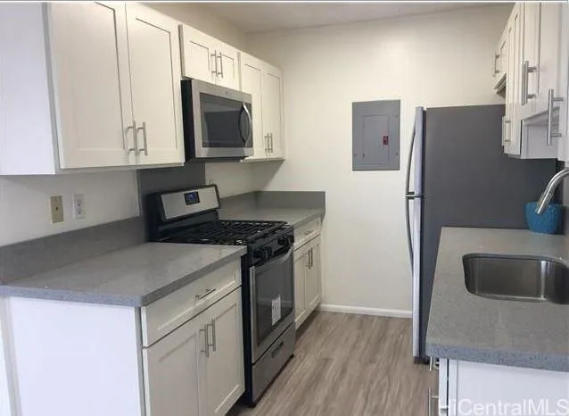 a kitchen with stainless steel appliances granite countertop a refrigerator sink and microwave