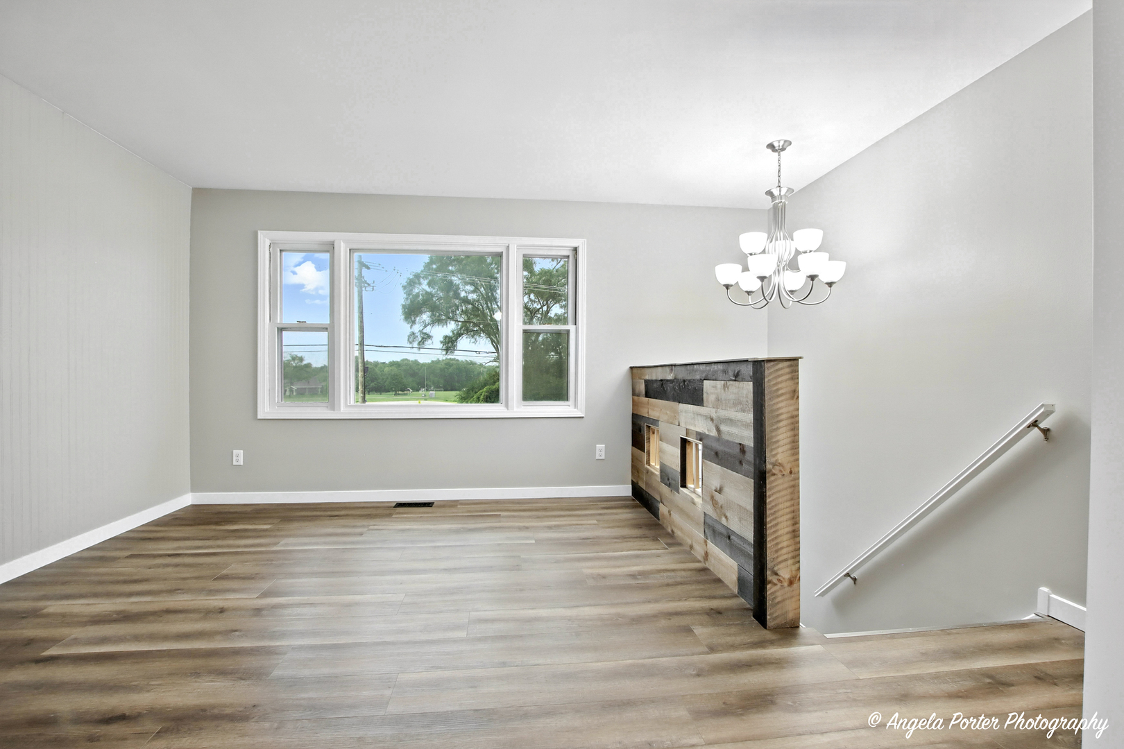 4117 North Johnsburg Road Johnsburg, IL 60051 - Photo 13 of 25 a view of an empty room with wooden floor and a window