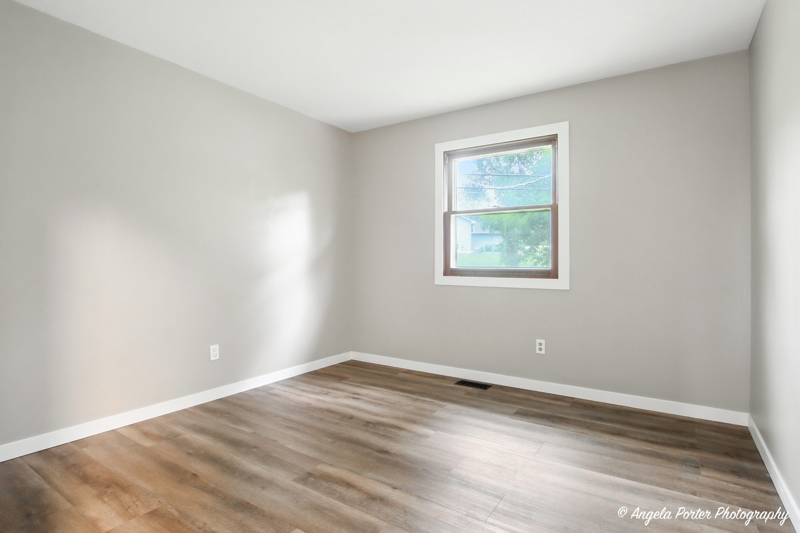 4117 North Johnsburg Road Johnsburg, IL 60051 - Photo 15 of 25 a view of an empty room with wooden floor and a window