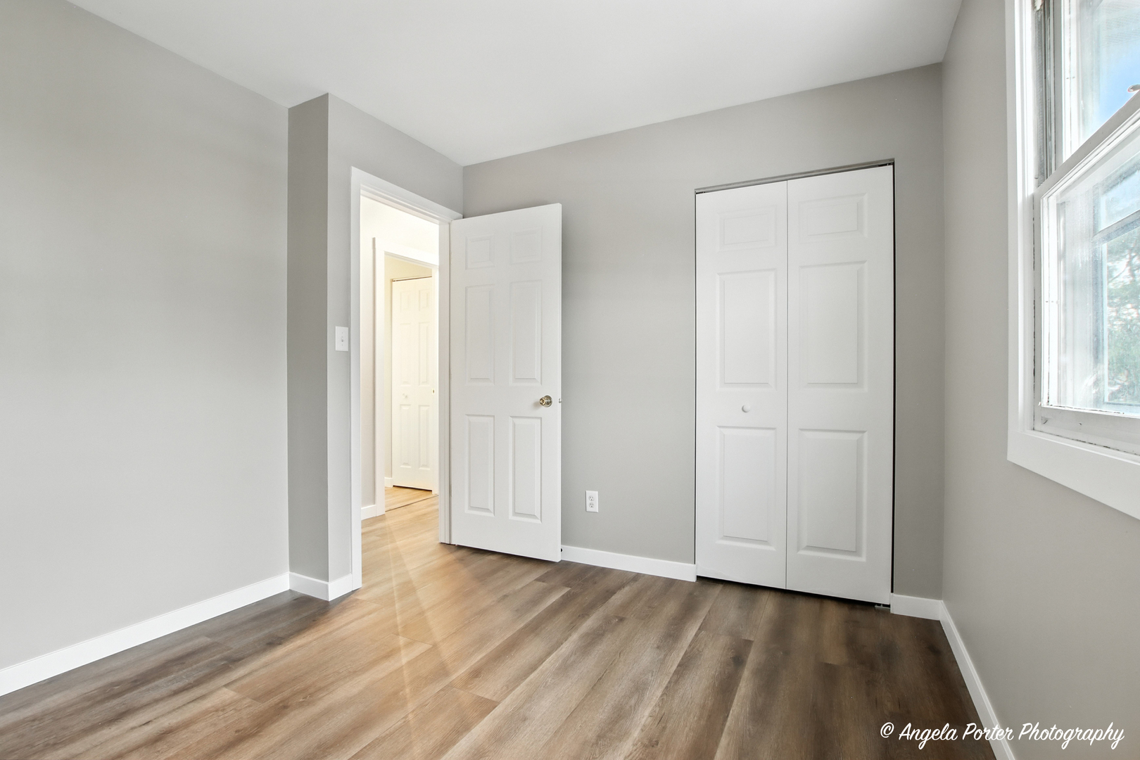 4117 North Johnsburg Road Johnsburg, IL 60051 - Photo 16 of 25 an empty room with wooden floor and windows