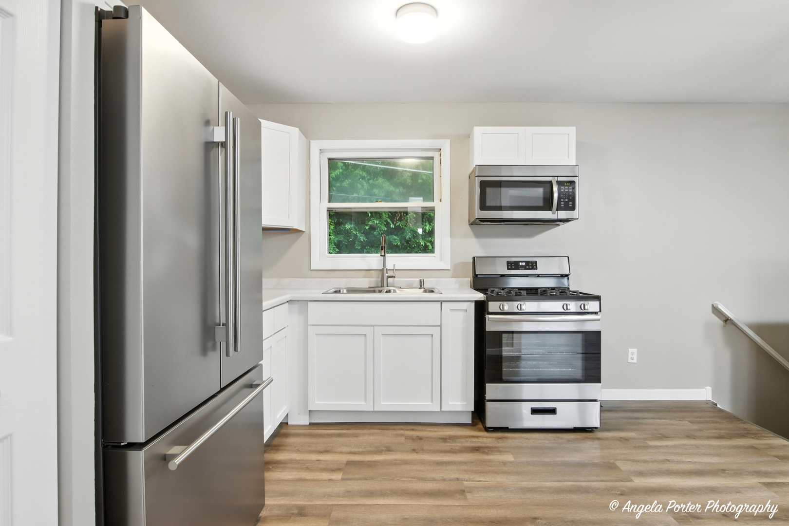 4117 North Johnsburg Road Johnsburg, IL 60051 - Photo 9 of 25 a kitchen with stainless steel appliances a refrigerator stove and microwave