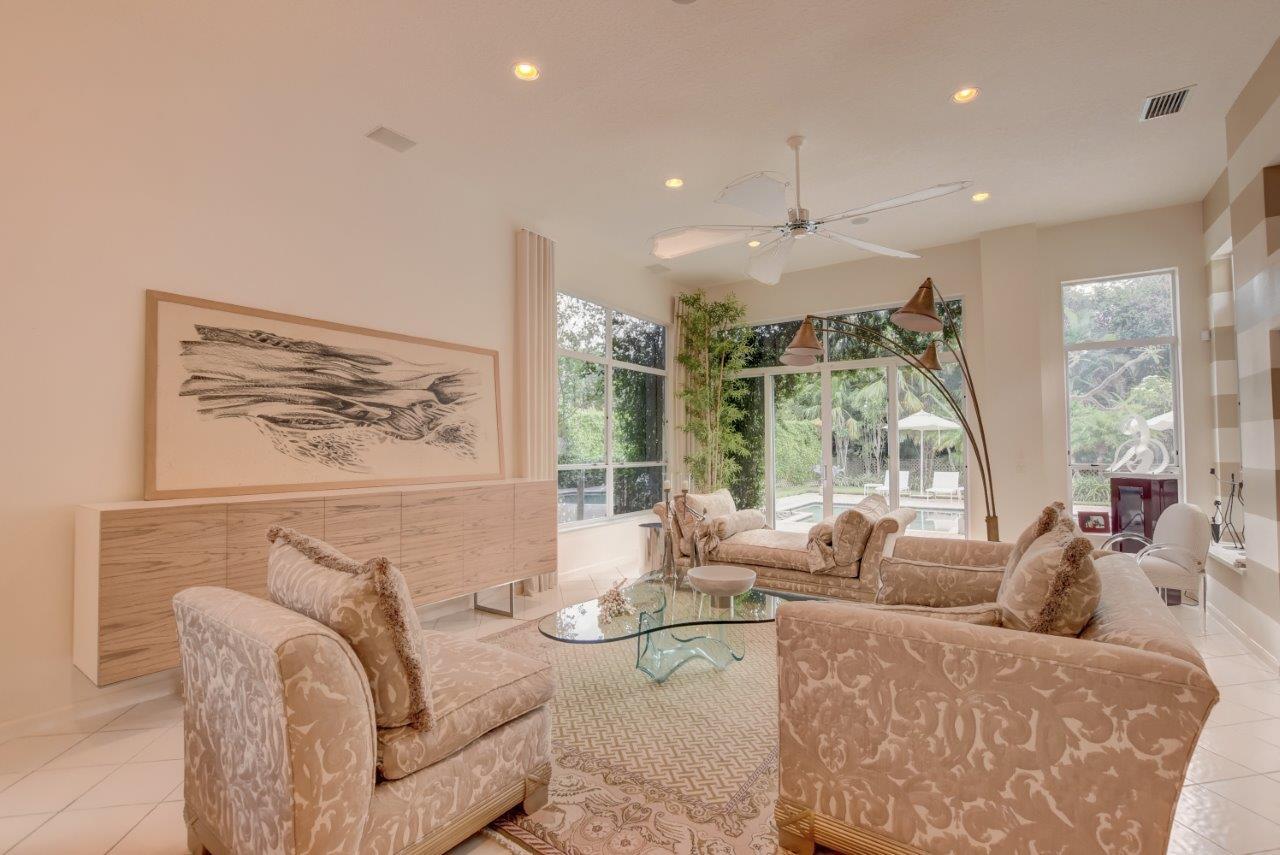 5758 Northwest 24th Terrace Boca Raton, FL 33496 - Photo 12 of 35 a living room with furniture and a chandelier