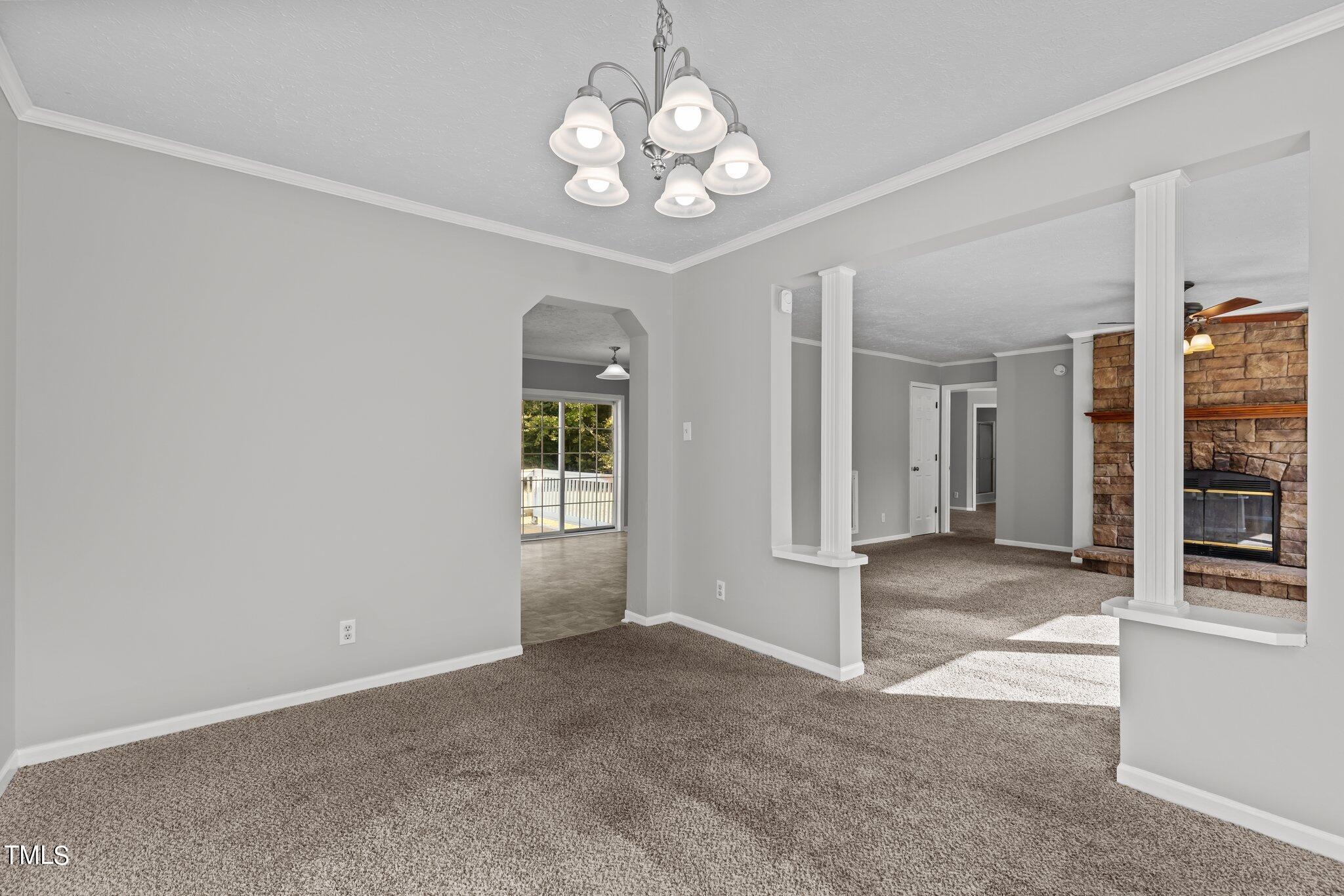 89 Munday Road Roxboro, NC 27574 - Photo 15 of 46 a view of a livingroom with a chandelier fan and windows