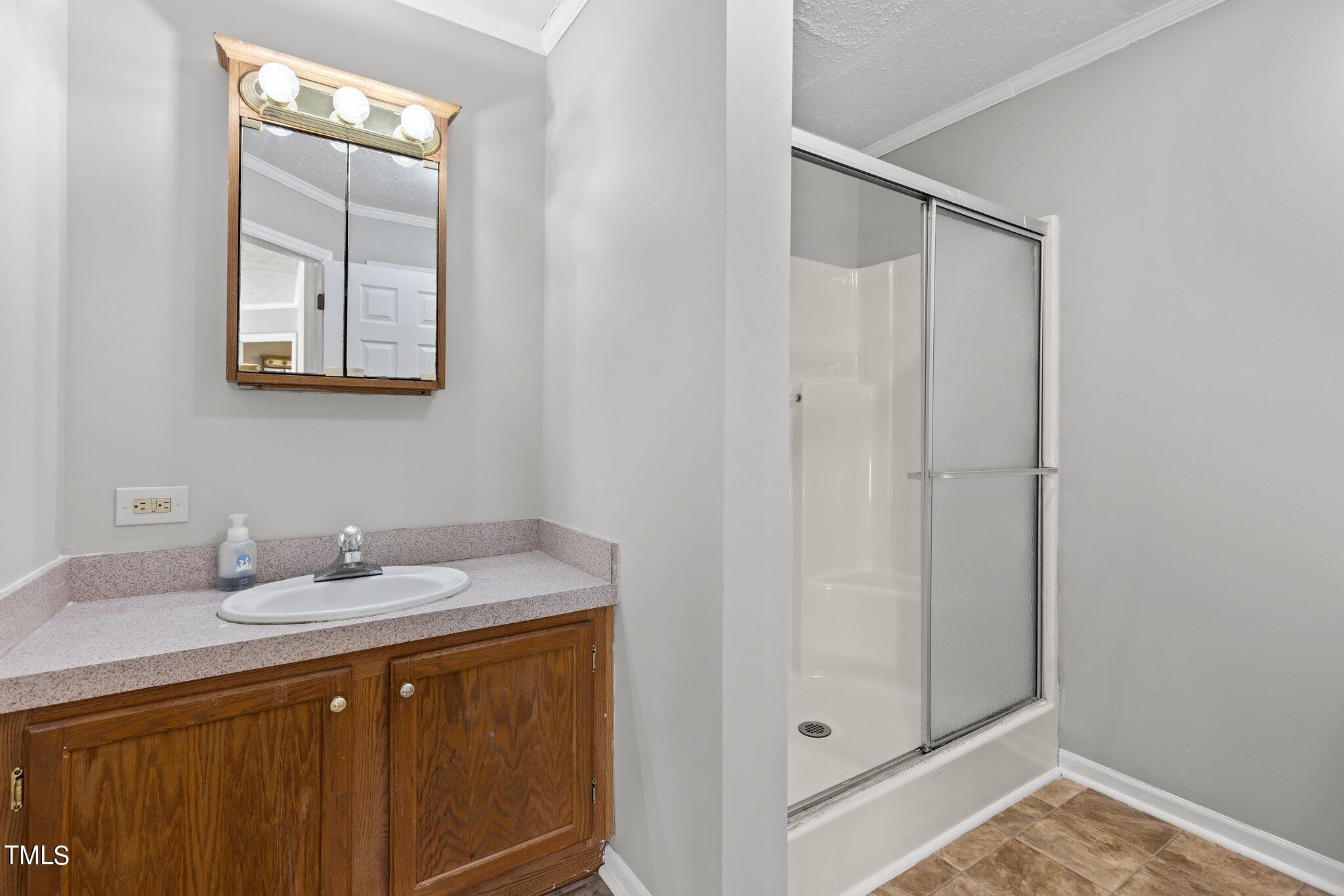 89 Munday Road Roxboro, NC 27574 - Photo 20 of 46 a bathroom with a sink and a mirror