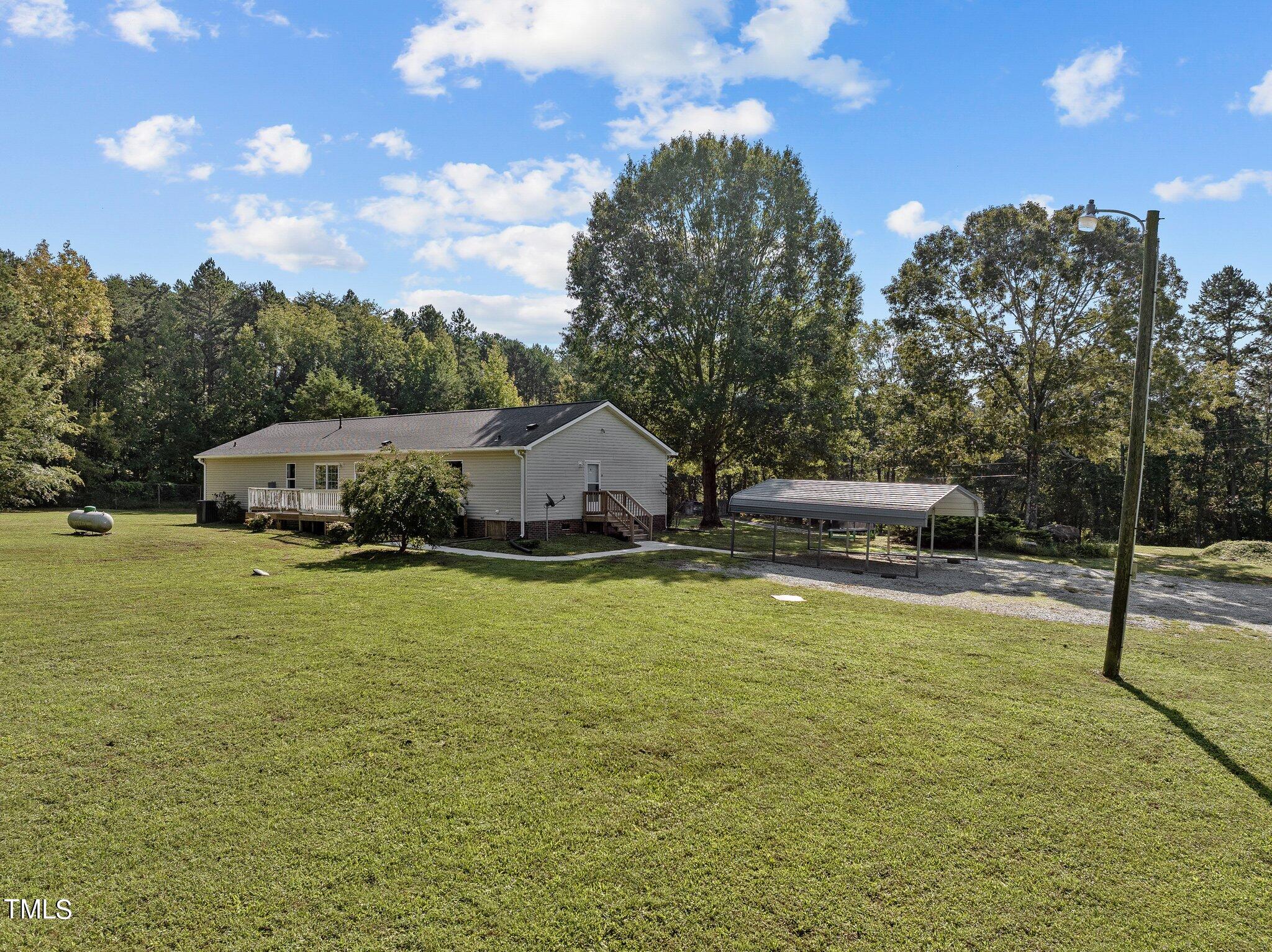 89 Munday Road Roxboro, NC 27574 - Photo 26 of 46 a swimming pool with lots of tress in the background