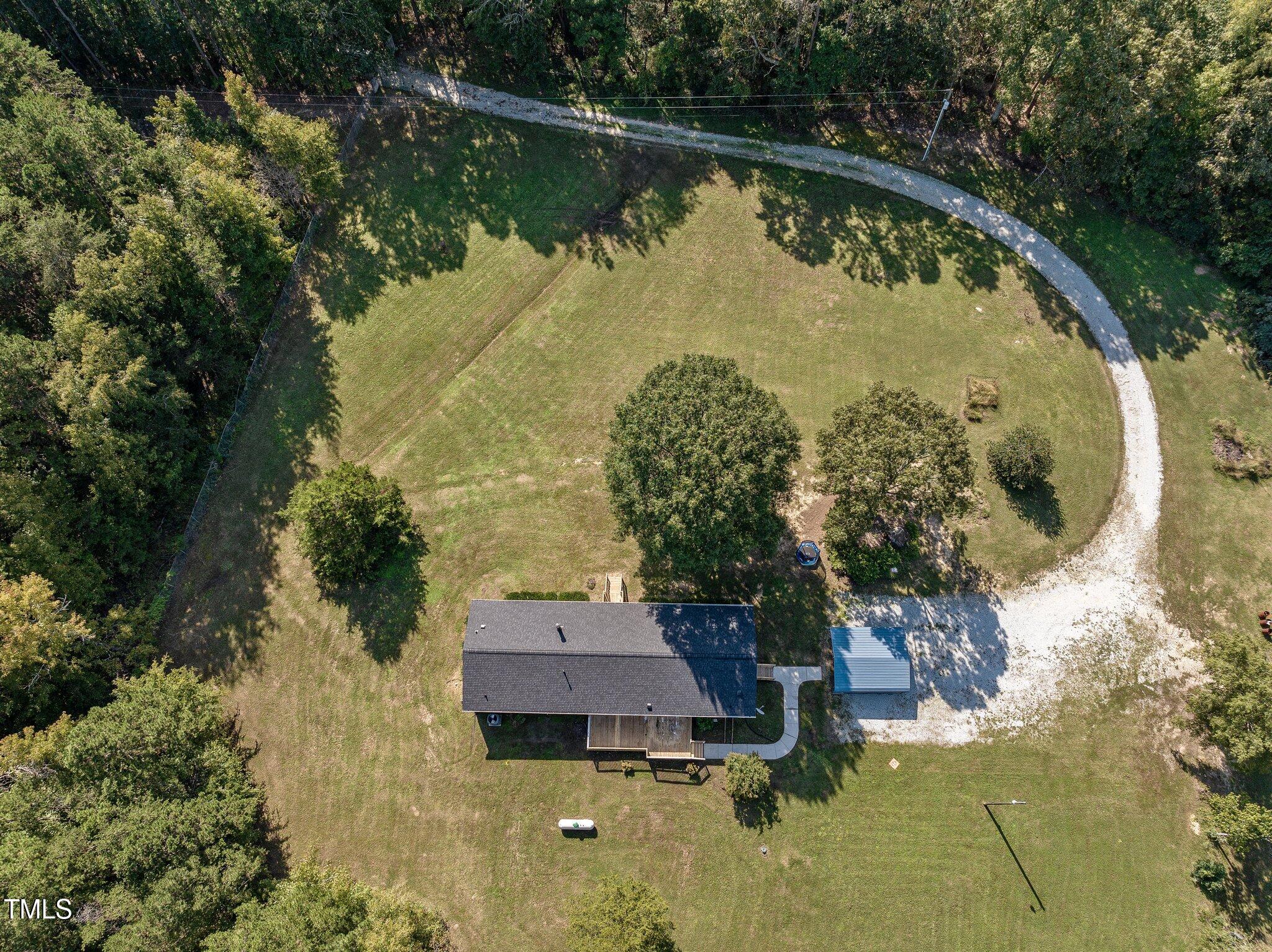 89 Munday Road Roxboro, NC 27574 - Photo 29 of 46 an aerial view of lake residential house with outdoor space and trees around